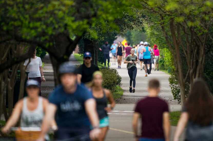 Runners, walkers and cyclists take to the Katy Trail near Knox Street on Thursday, March 19,...