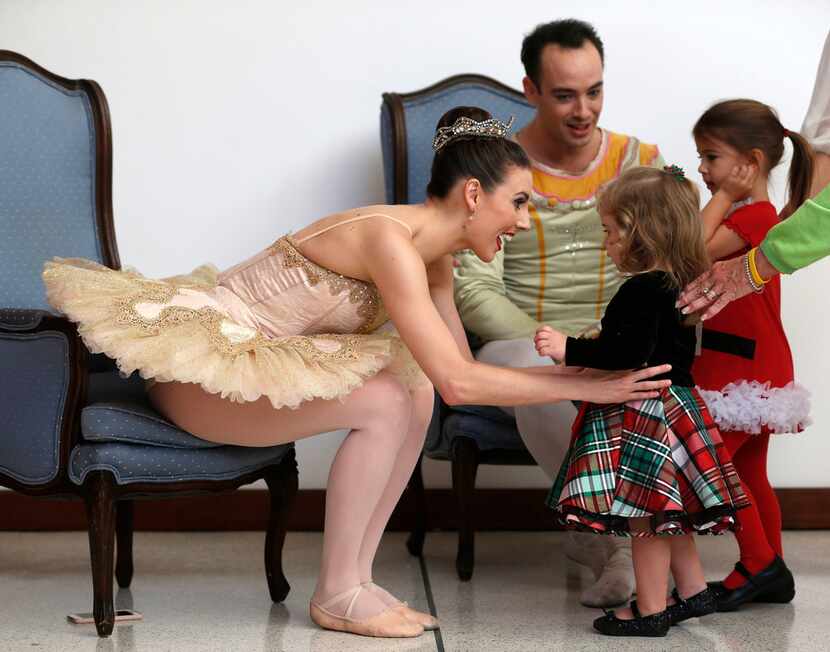 New York City Ballet principal dancers Tiler Peck and Tyler Angle greet Mary Kellerman, 2,...