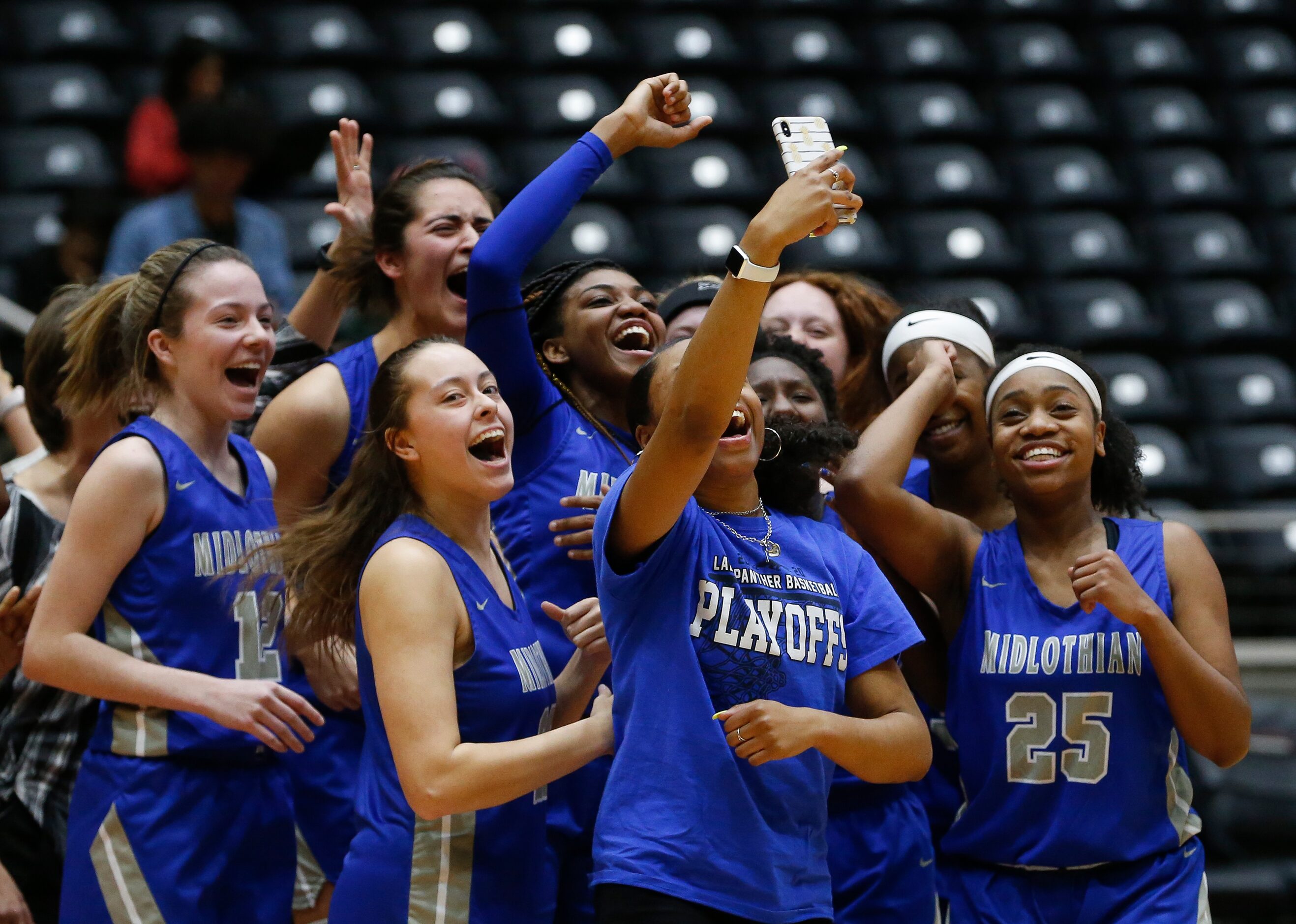 Midlothian celebrates their Class 5A Region II girls basketball semifinal win over Frisco...