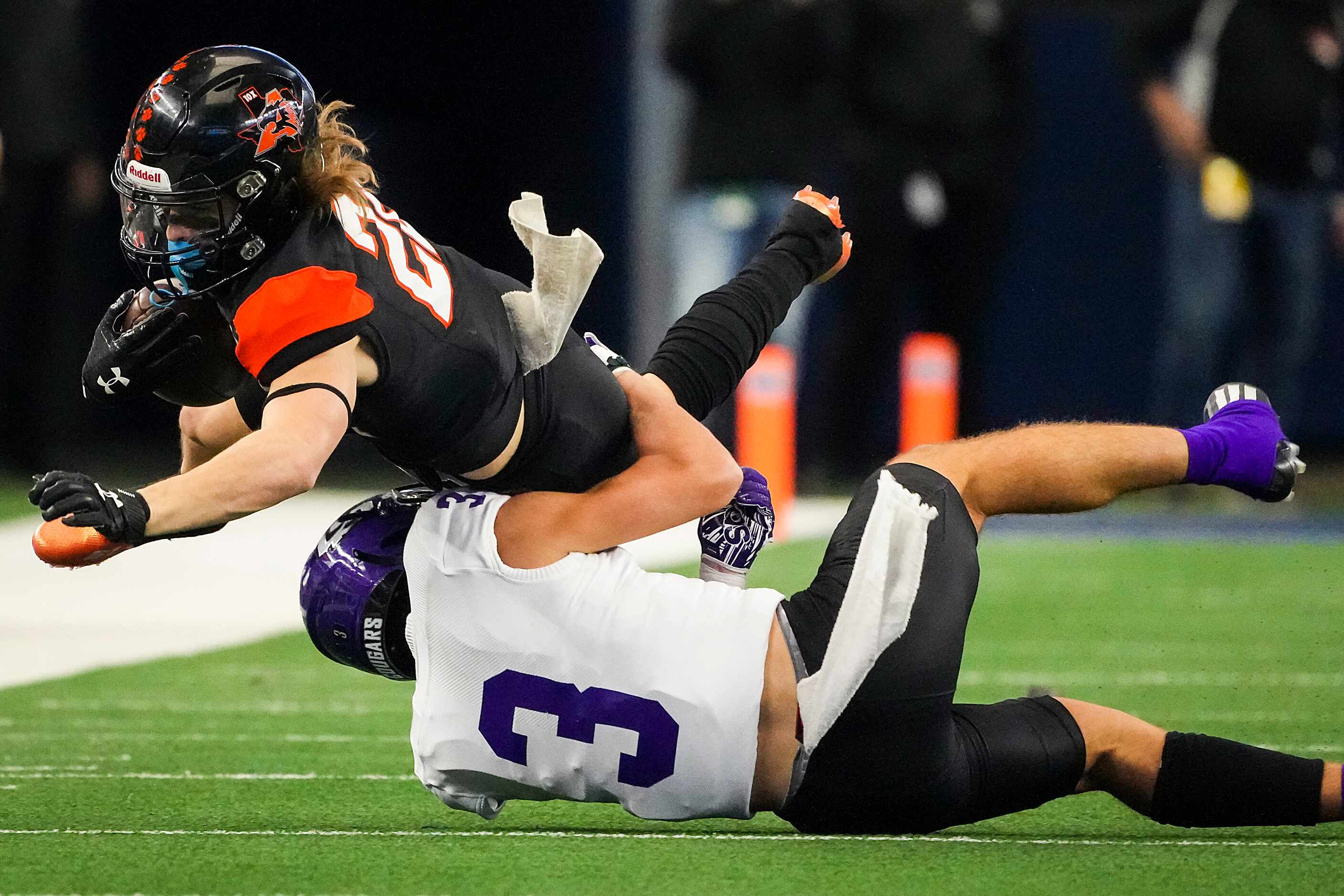 Aledo wide receiver Gavin Olenjack (22) is brought down by College Station wide receiver...
