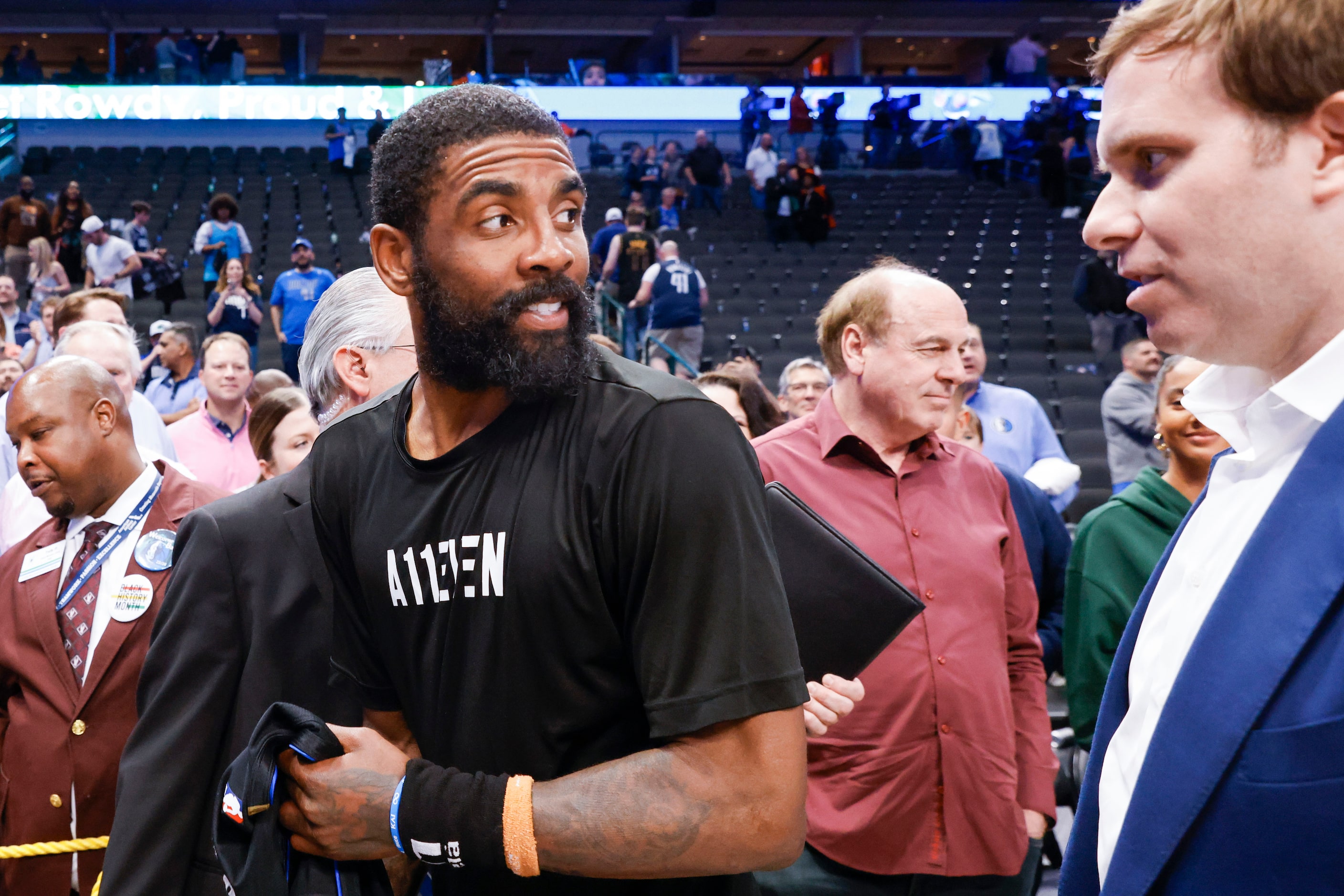 Dallas Mavericks guard Kyrie Irving (left) talks to Dallas Mavericks Governor Patrick Dumont...