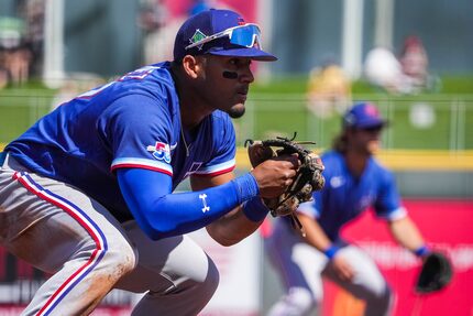 Texas Rangers infielder Andy Ibáñez takes a defensive position at third base during the...