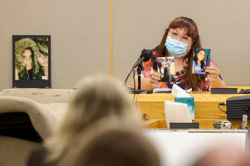 Patricia Owens holds up photos of her daughters 18-year-old Amina Said (center) and...