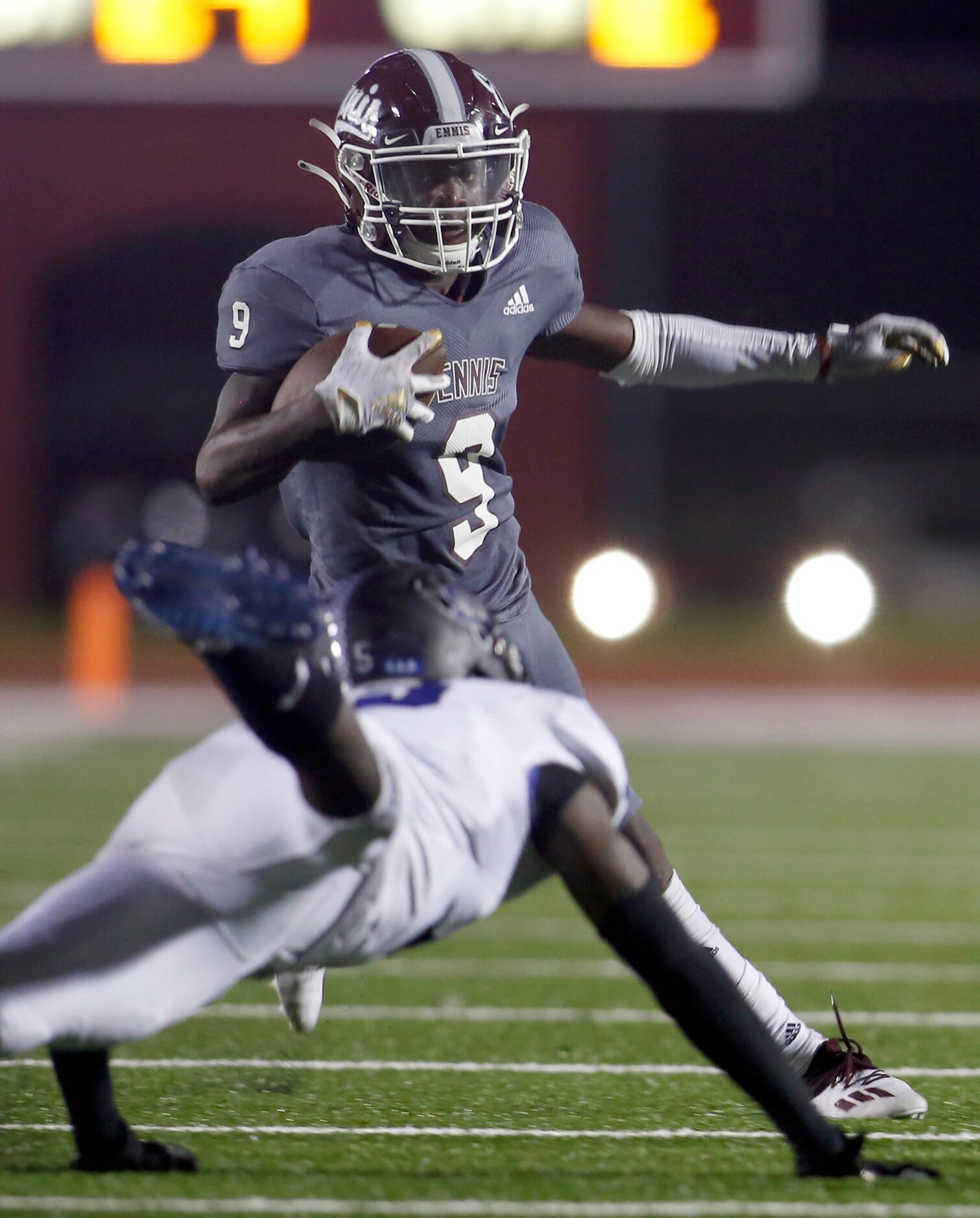 Ennis receiver Devion Beasley (9) tacks on yardage as Mansfield Summit defensive back Justin...