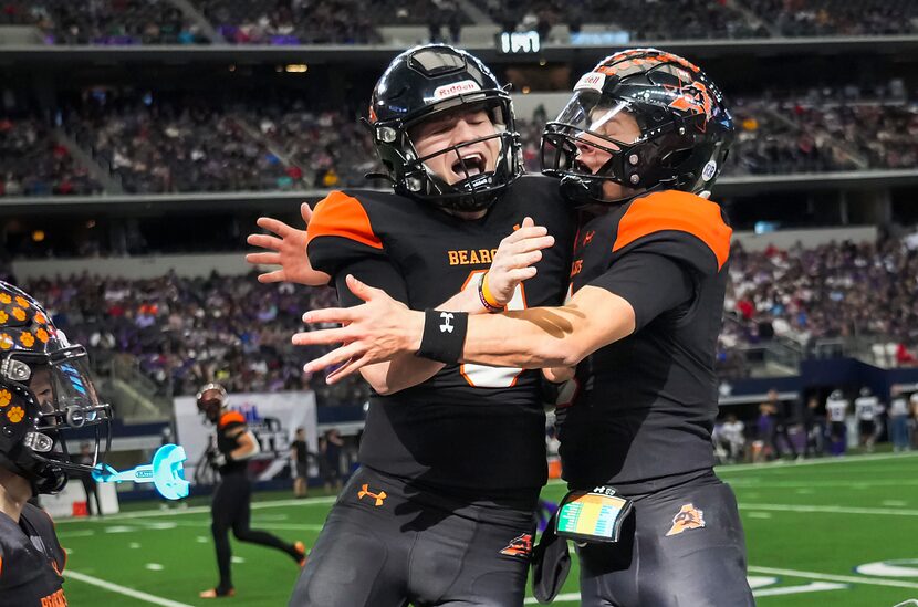 Aledo quarterback Hauss Hejny (center) celebrates with teammate Brant Hayden (right) after...