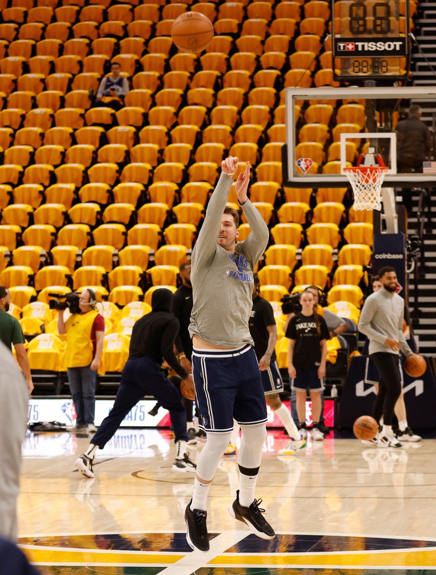 Dallas Mavericks guard Luka Doncic (77) shoots and makes a half court shot during warmups...