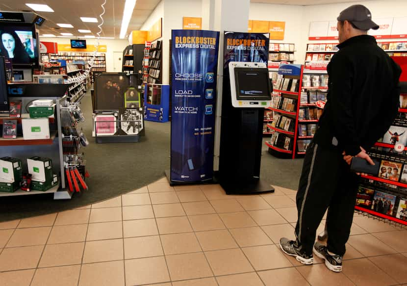 Patron Richard Daly of Dallas checks out the Blockbuster Express Digital downloading kiosk...