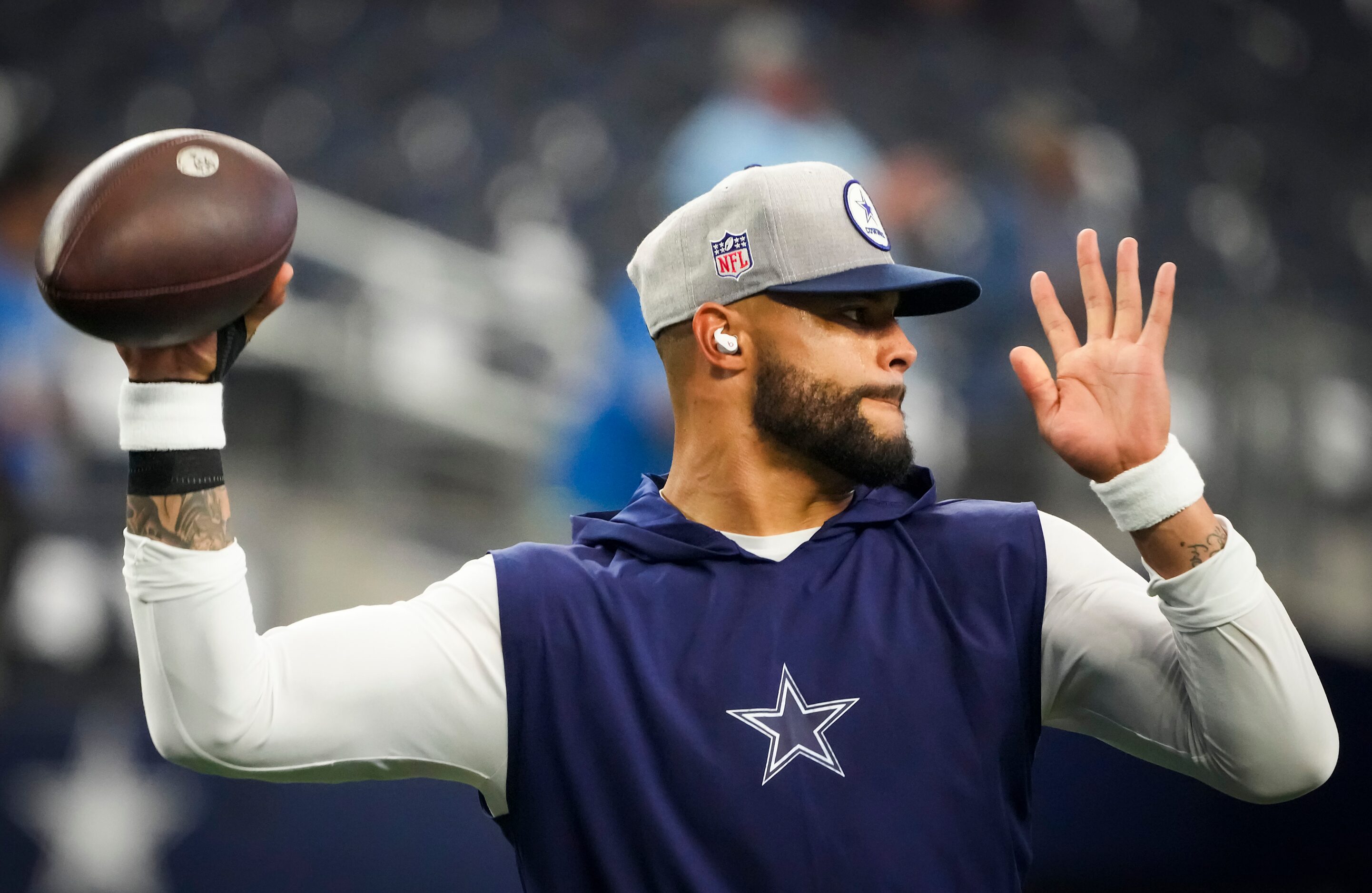 Dallas Cowboys quarterback Dak Prescott warms up before an NFL football game against the...