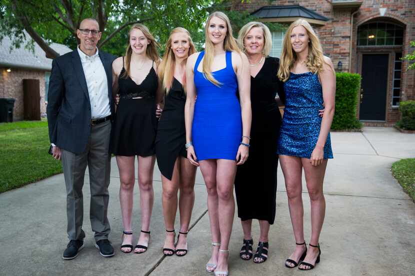 Basketball player Lauren Cox (center) poses for a photo with her family outside their home...