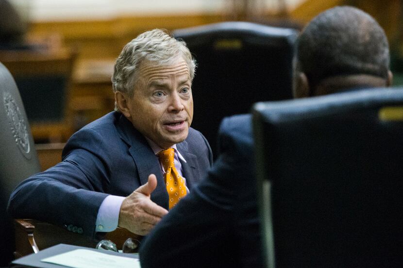 Sen. Don Huffines talks to Sen. Royce West during a midnight session on the third day of a...