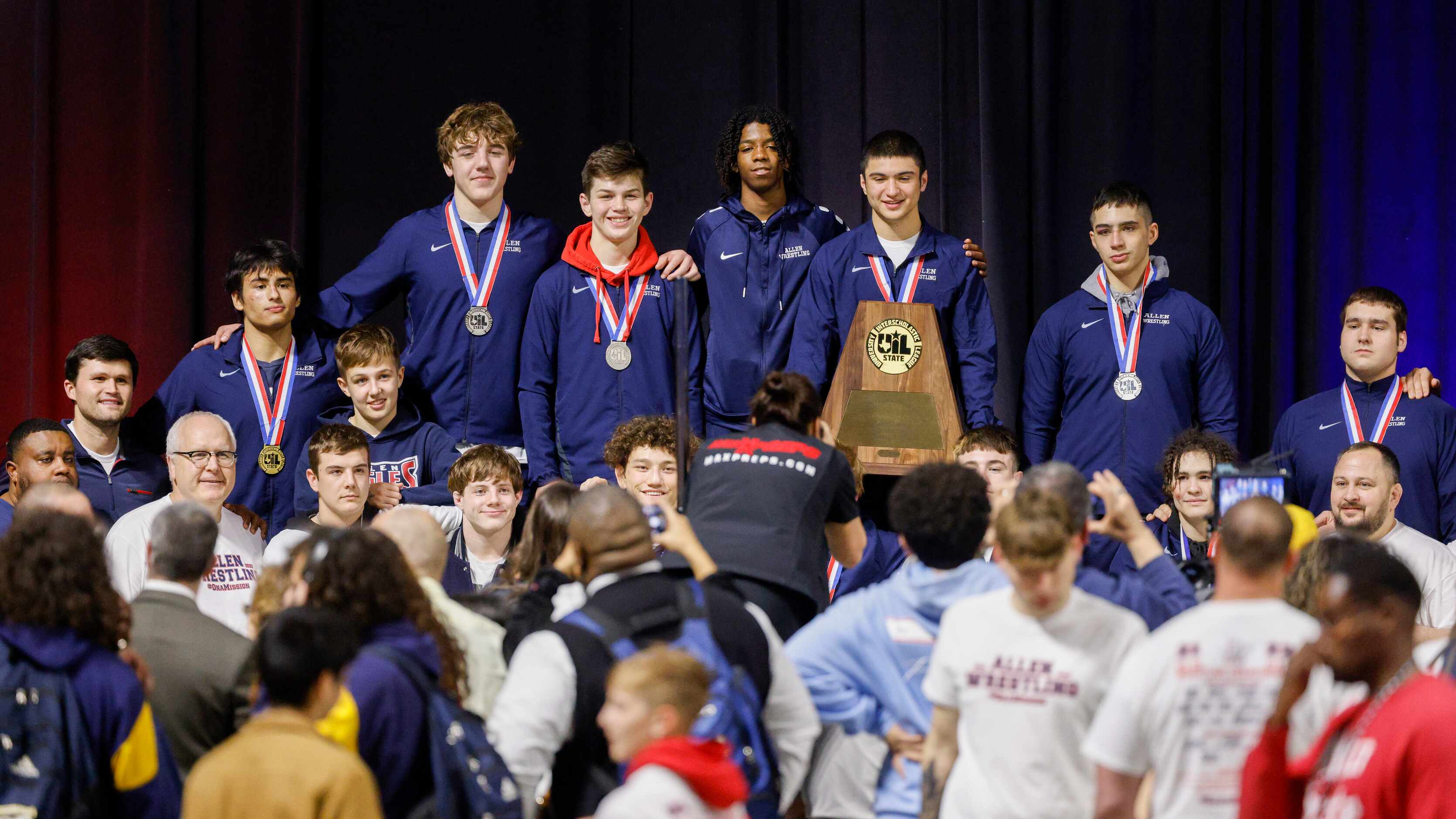 Members of the Allen team pose for photos with the boys 6A team state championship trophy at...
