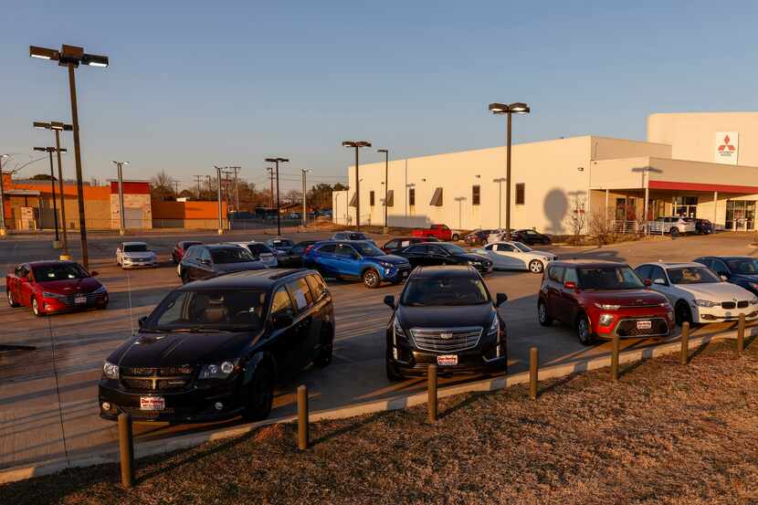 Used cars sit for sale at a Don Herring Mitsubishi dealership on Feb. 10 in Irving.