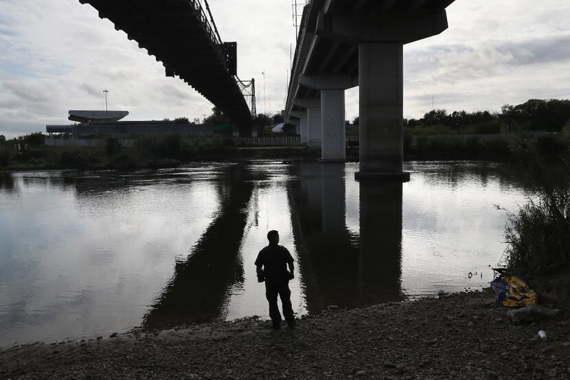 ROMA, TX - MARCH 13:  A U.S. Border Patrol agent looks into Mexico from the bank of the Rio...