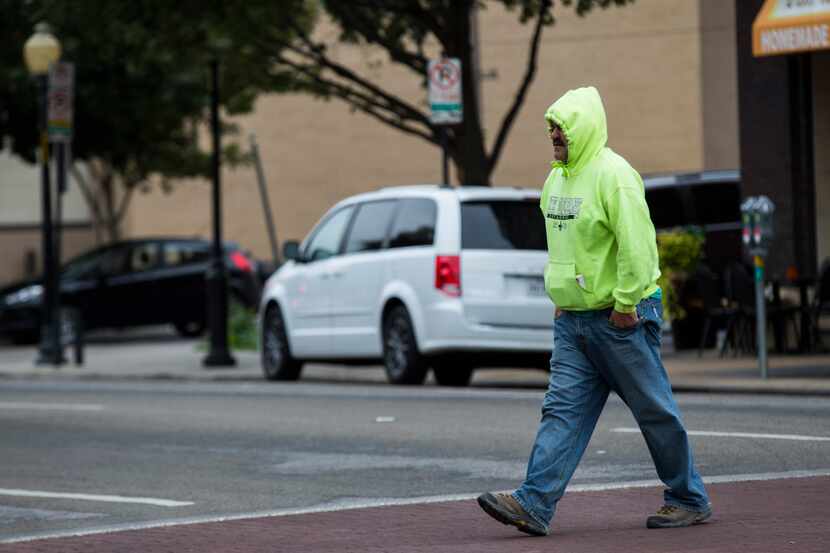 Dallas-area residents got out their hoodies to navigate the chill on Commerce Street...