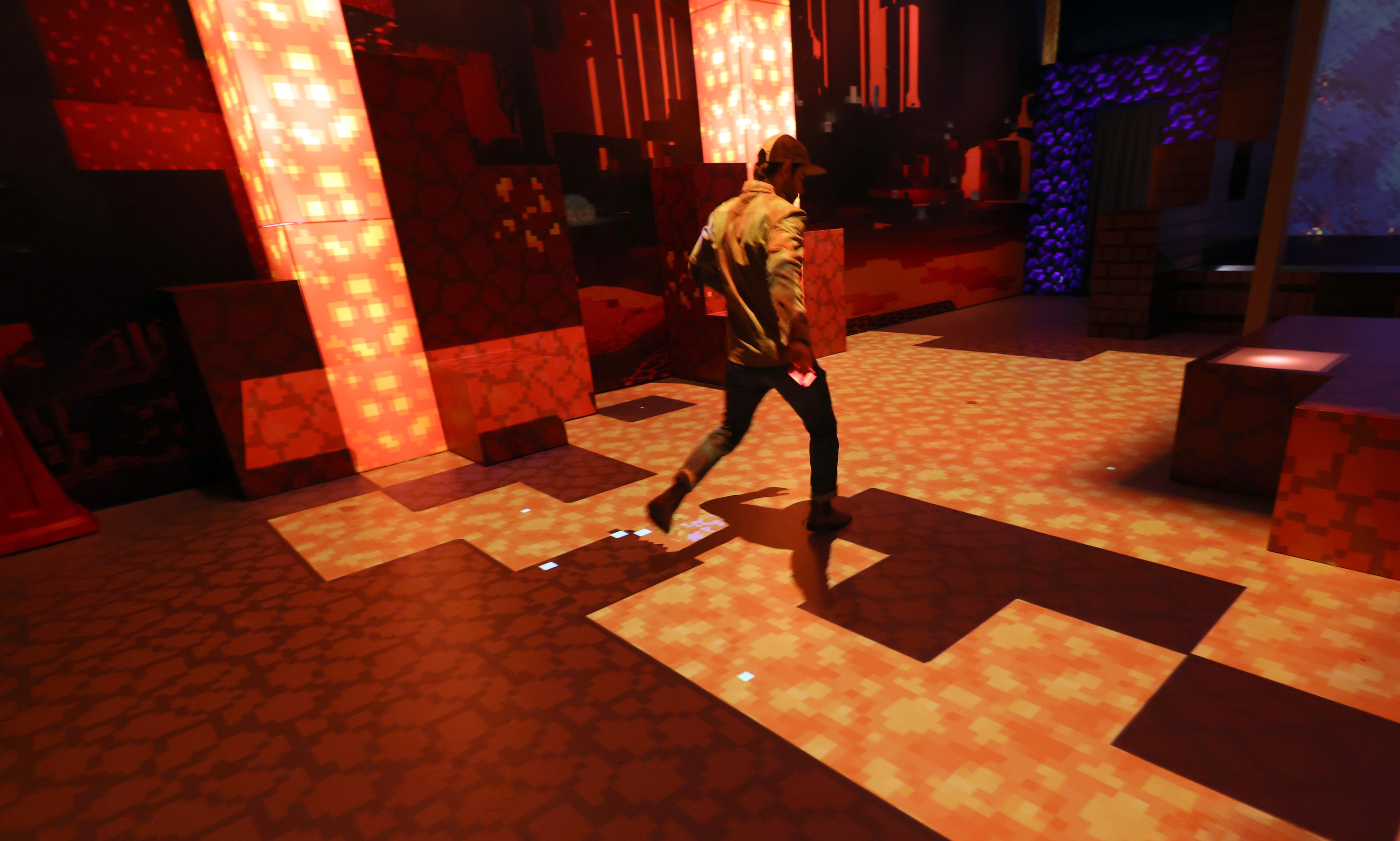 Olivier Goulet, Executive Producer of Minecraft Experience, leaps to follow a path while...