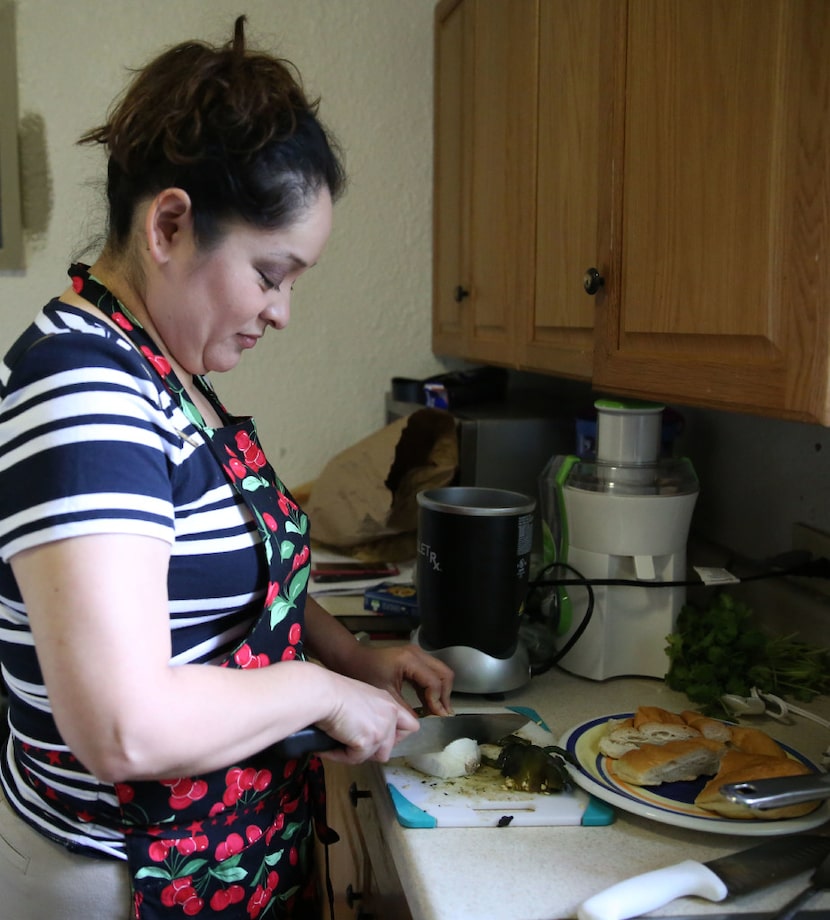 Carolina Maldonado, pitmaster at Lockhart Smokehouse, chops an onion while making Poblano...