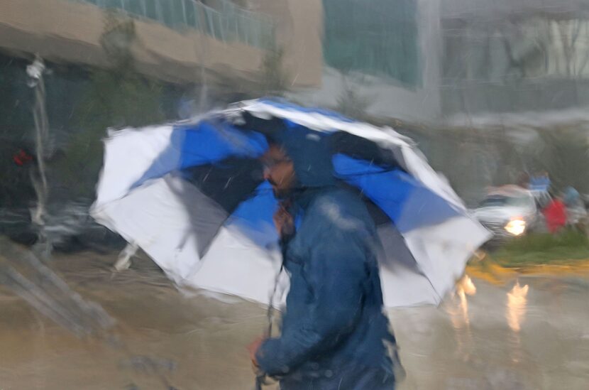 Evacuees and volunteers brave the constant downpour to get to the George Brown Convention...