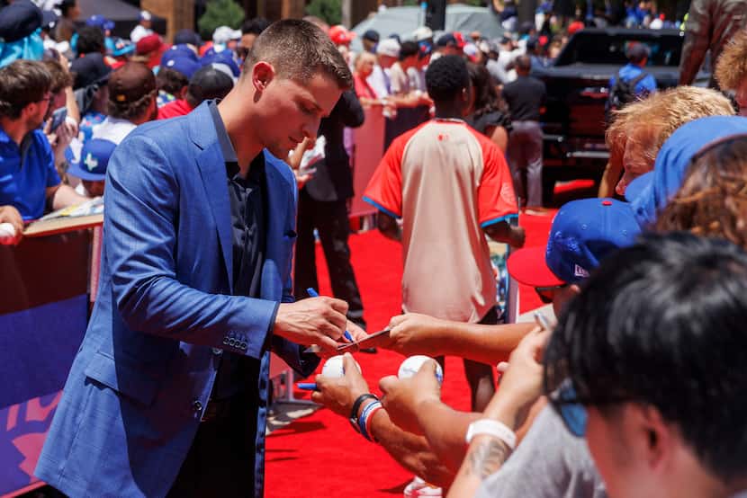 Texas Rangers shortstop Corey Seager signs autographs during the MLB All-Star Red Carpet...