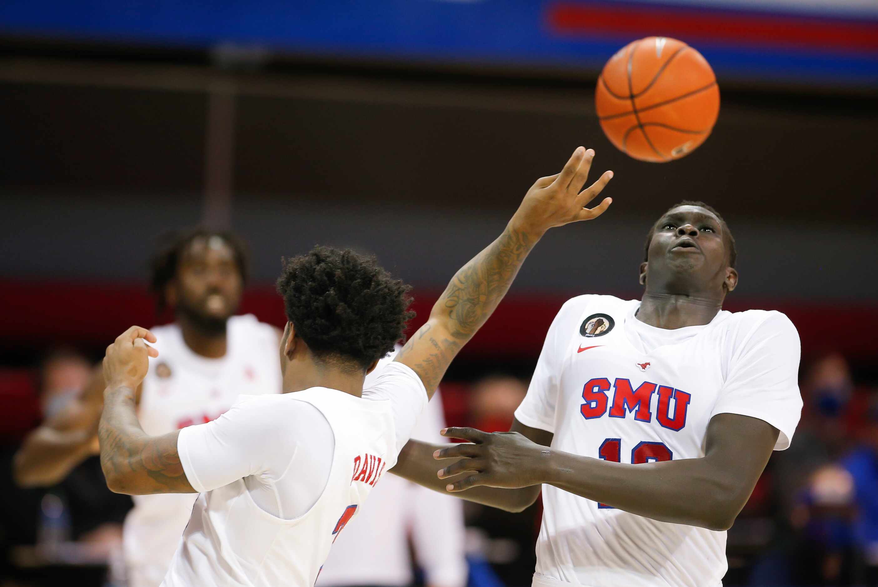 SMU guard Kendric Davis, left, and forward Yor Anei (10) vie for a rebound during the second...
