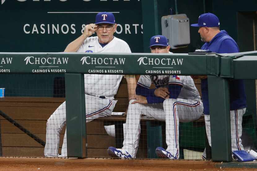 Texas Rangers manager Bruce Bochy (15), left, watches his players during the fifth inning of...
