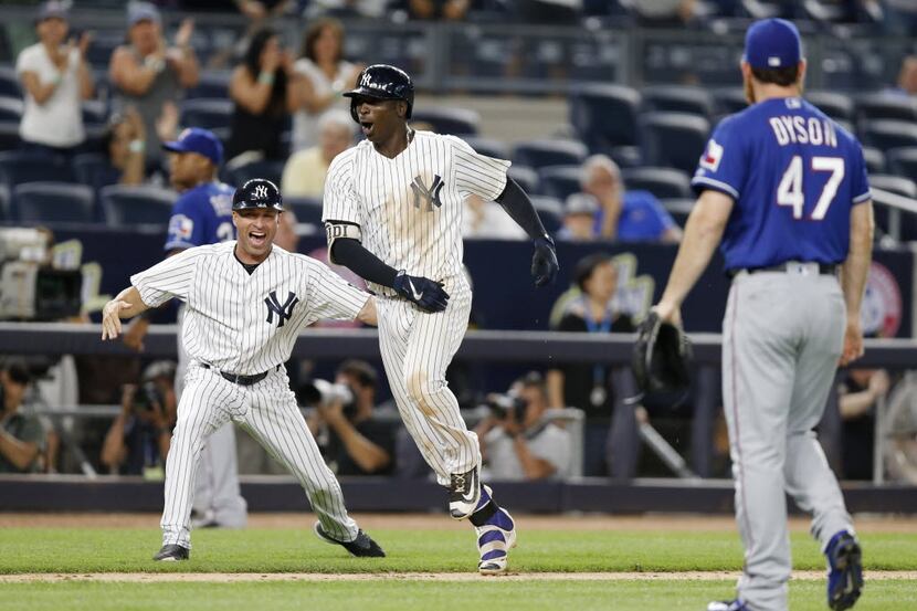 New York Yankees third base coach Joe Espada, left, celebrates as the Yankees' Didi...