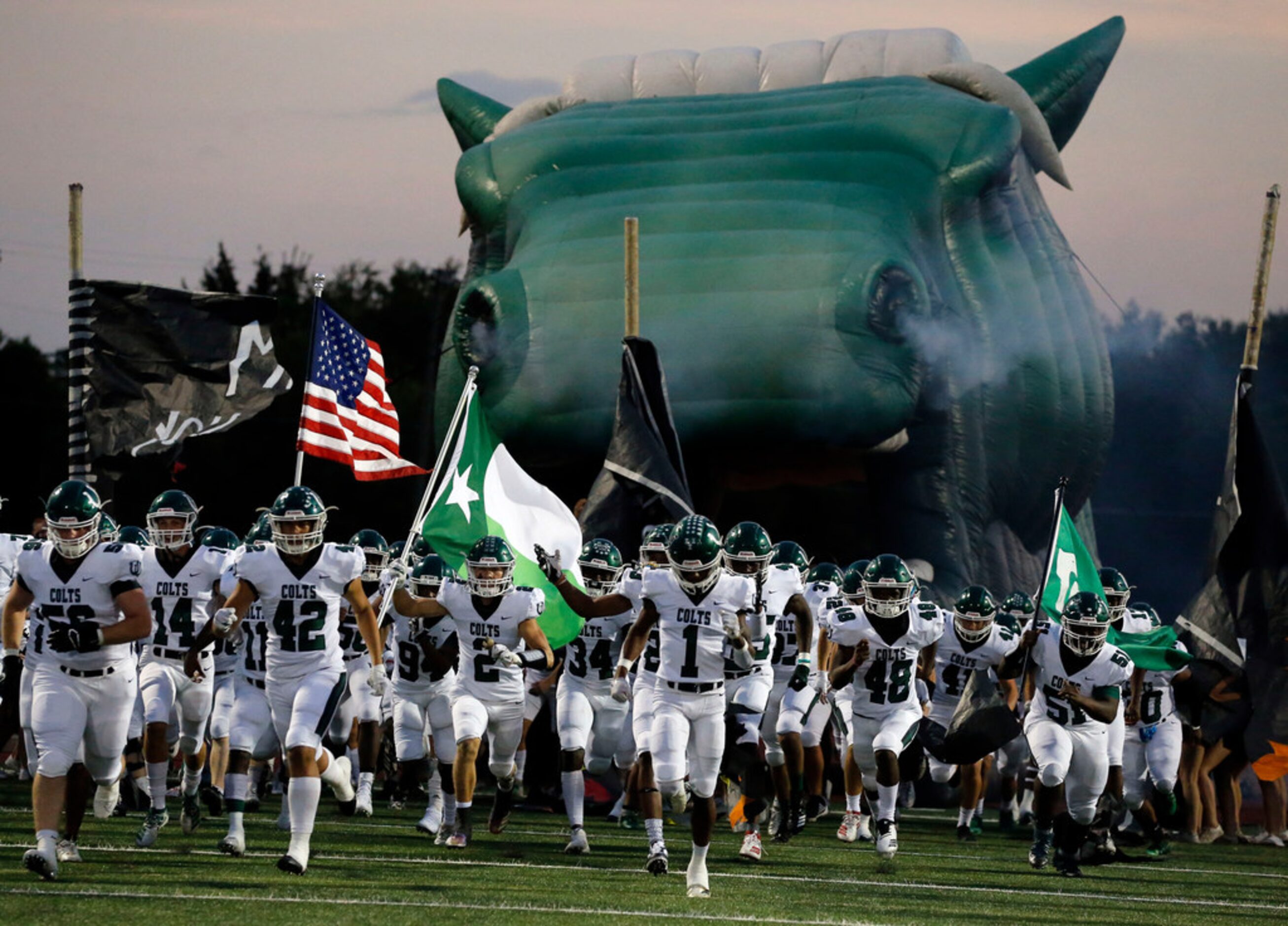 The Arlington high Colts enter the field through a giant horses's head (with making...