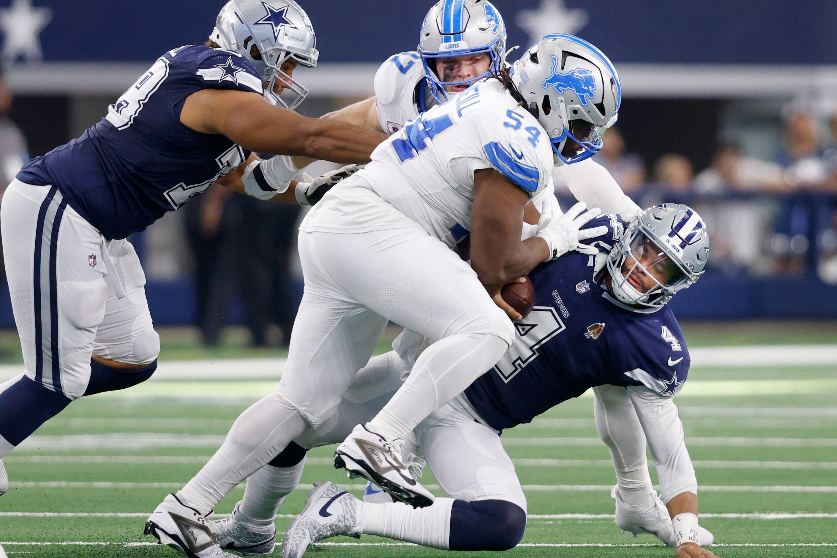 Dallas Cowboys quarterback Dak Prescott (4) is sacked by Detroit Lions defensive tackle Alim...