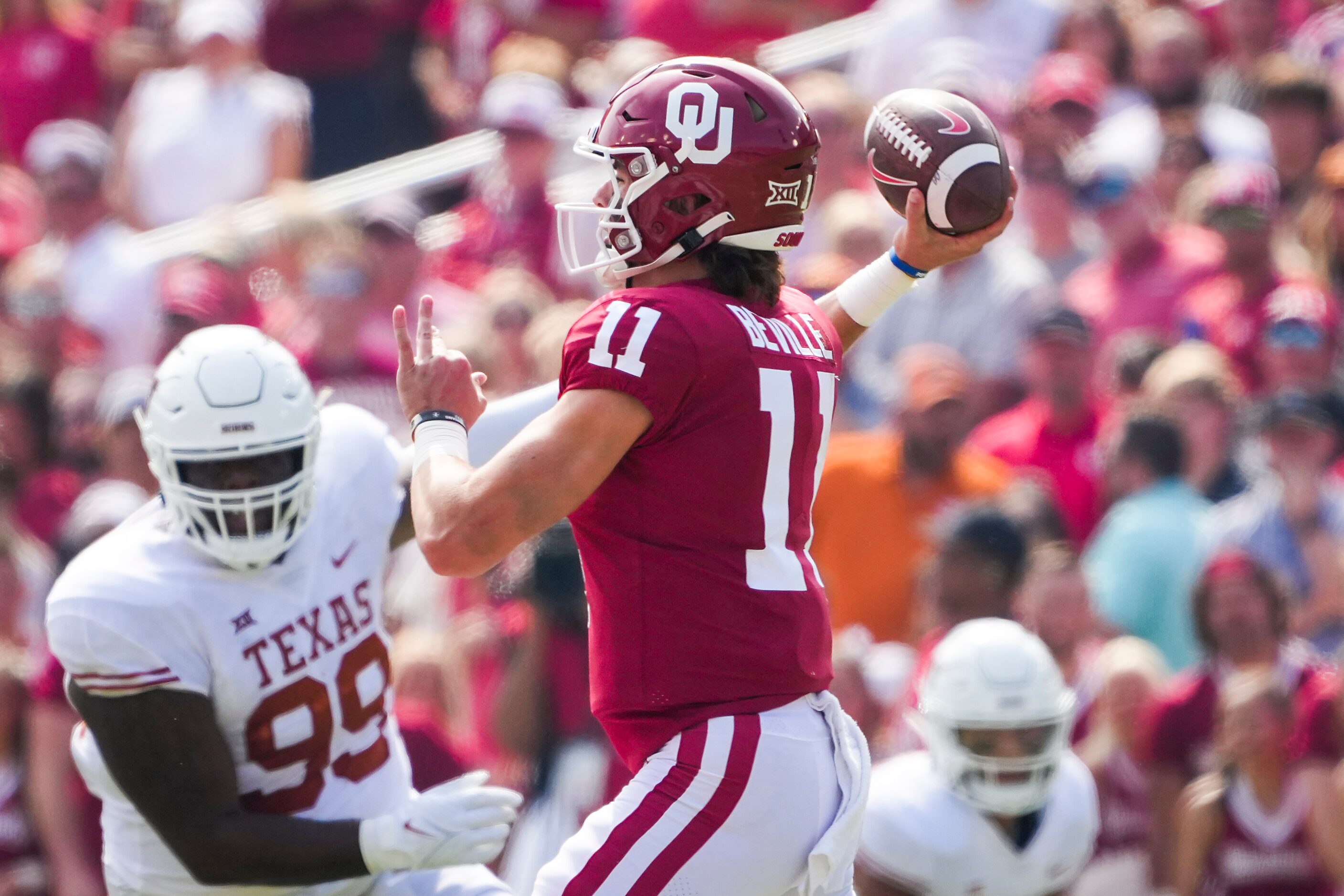 Oklahoma quarterback Davis Beville (11) throws a pass as Texas defensive lineman Keondre...