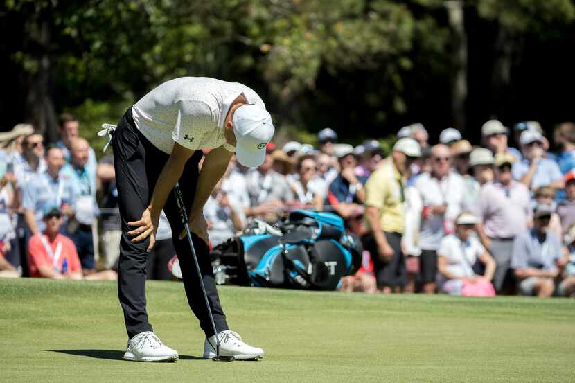 Jordan Spieth reacts to a missed birdie putt on the eighth green during the third round of...