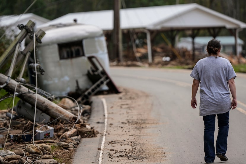 A woman walked to her damaged home in Pensacola, N.C., on Thursday, Oct. 3, 2024.