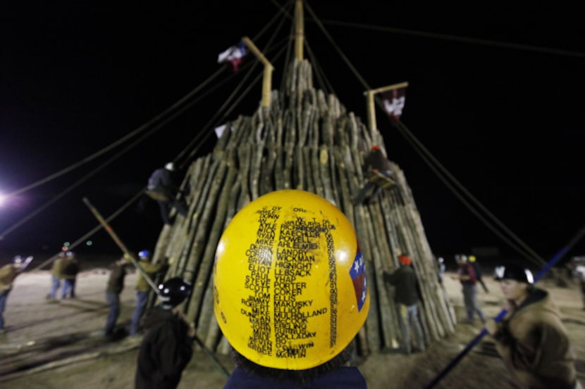 Yellow pot Cody Flores, wearing a helmet with the names and years of those before him, looks...