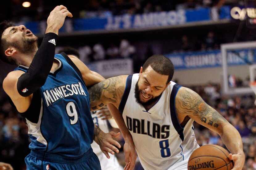 Dallas Mavericks guard Deron Williams (8) bumps Minnesota Timberwolves guard Ricky Rubio (9)...
