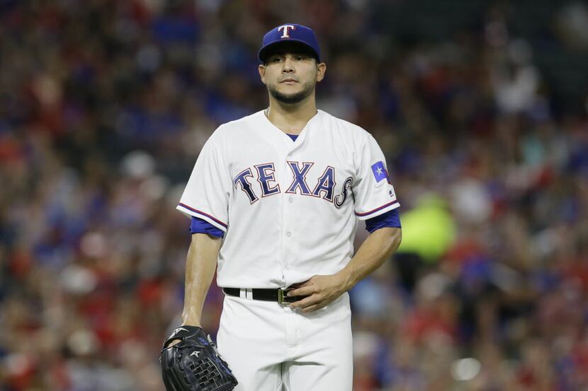 Texas Rangers starting pitcher Martin Perez stand on the mound during a baseball game...