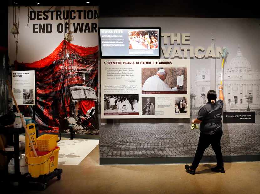 Beatriz Hernandez dusts an exhibit at the Dallas Holocaust and Human Rights Museum in...