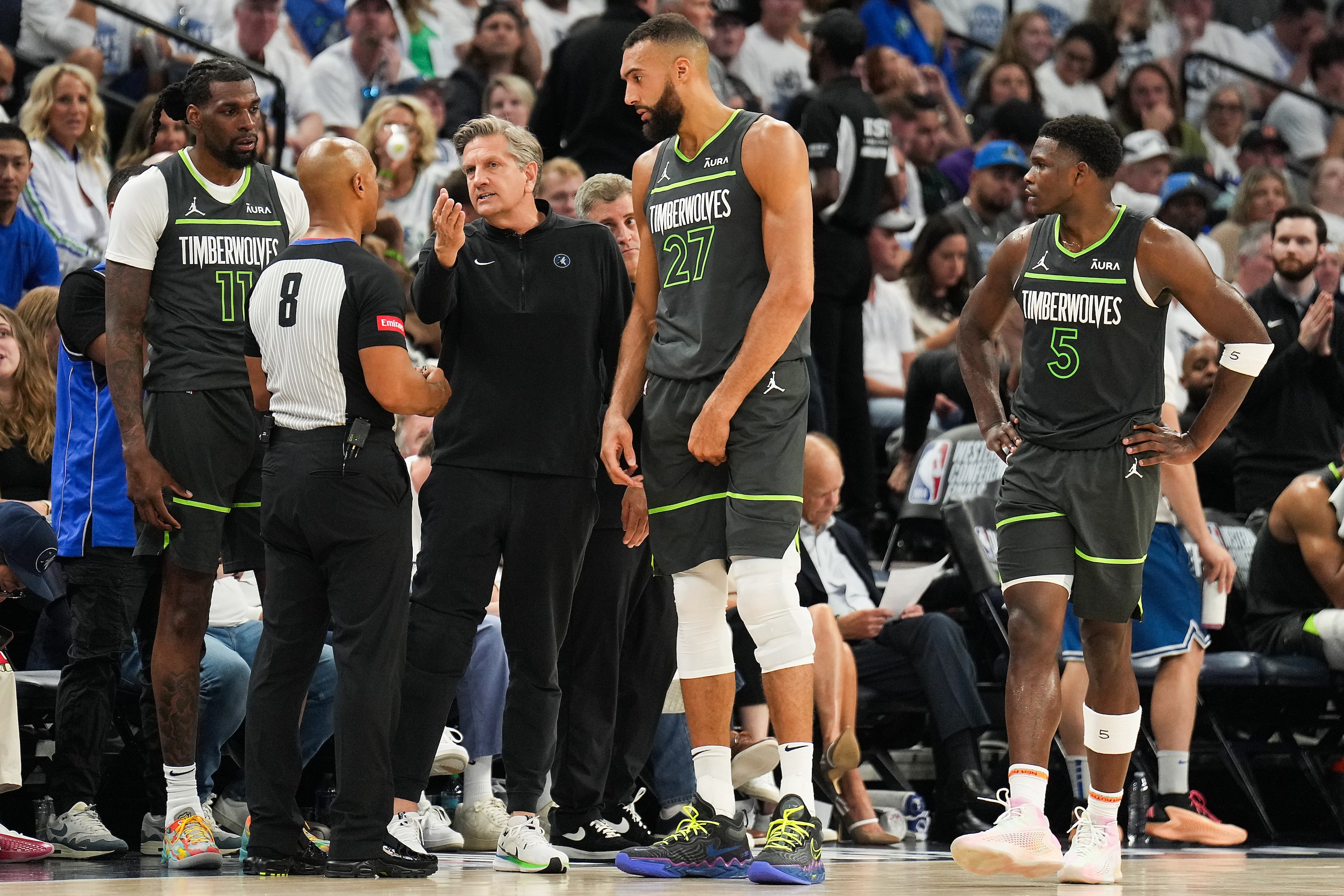 Minnesota Timberwolves head coach Chris Finch talks with referee Marc Davis (8) after center...