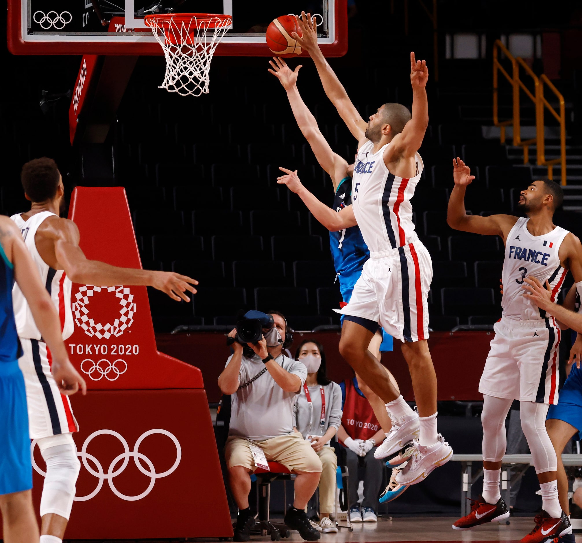 Slovenia’s Klemenn Prepelic (7) last second shot is blocked by France’s Nicolas Batum (5) at...