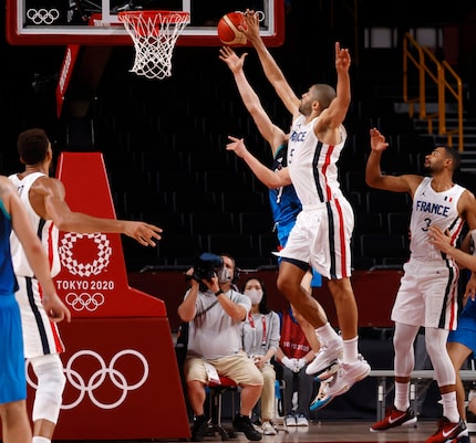 Slovenia’s Klemenn Prepelic (7) last second shot is blocked by France’s Nicolas Batum (5) of...