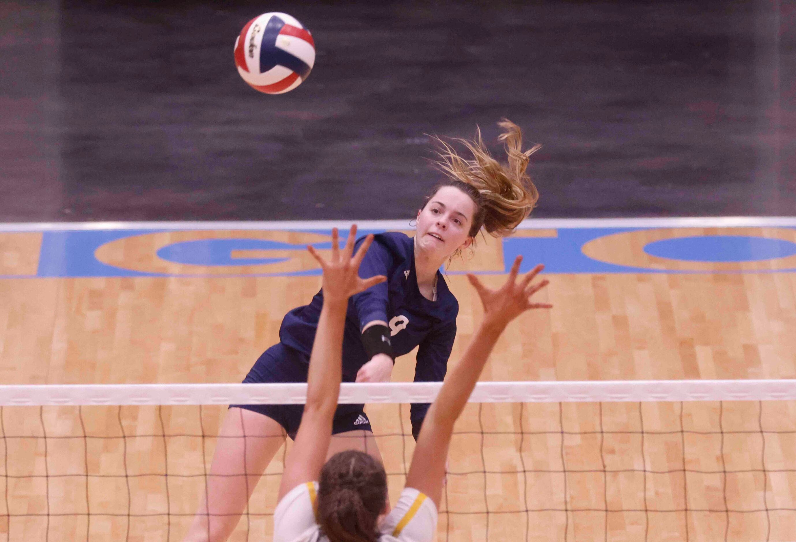 Flower Mound’s Cat Young (9) hits the ball against Highland Park High during a volleyball...