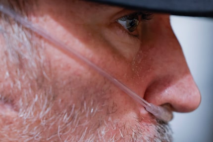 Josh Welch uses a nasal oxygen cannula as he talks to his wife, Emily, at their home in Plano.