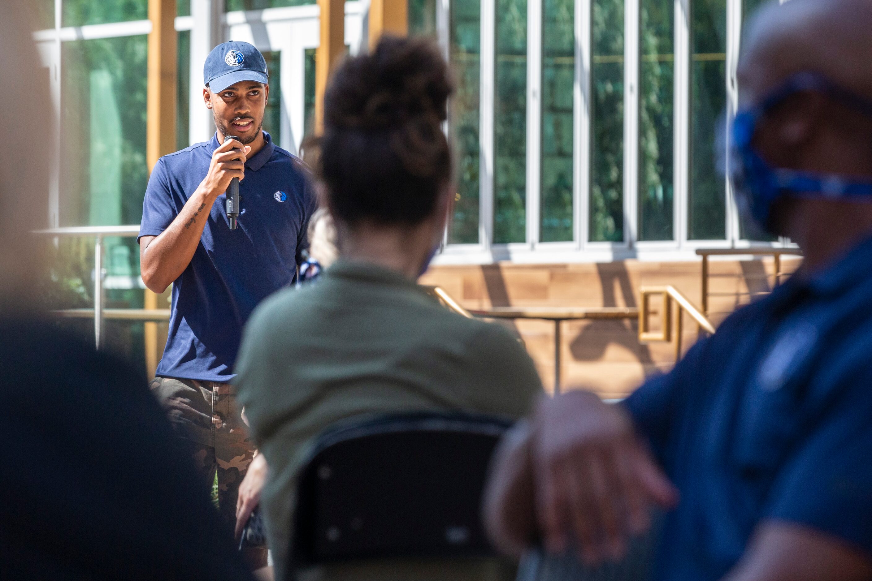 Dallas Mavericks employee Brandon Barkley speaks during a Courageous Conversations meet-up...