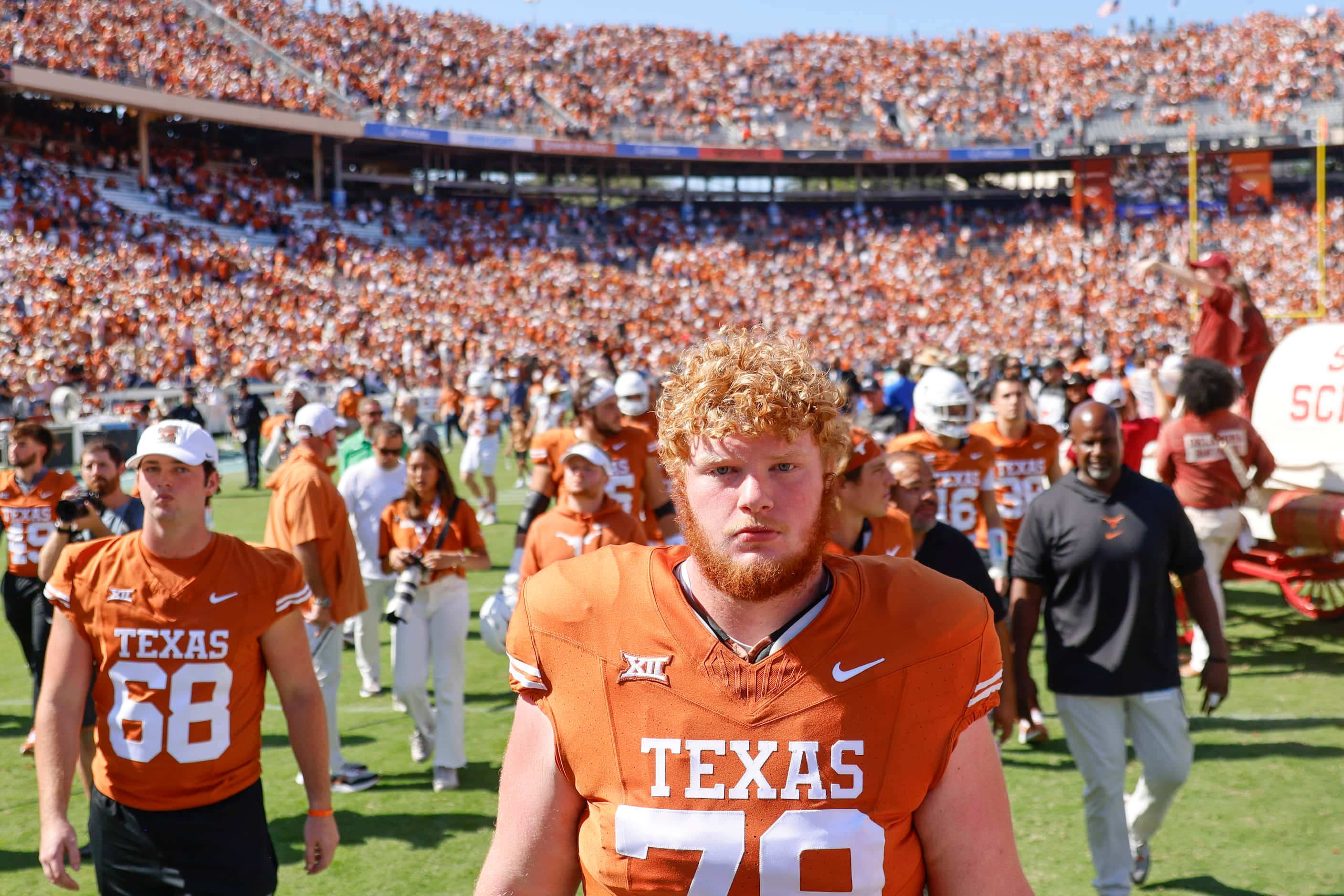 Texas players including Texas offensive lineman Connor Stroh (79) leave the field after...