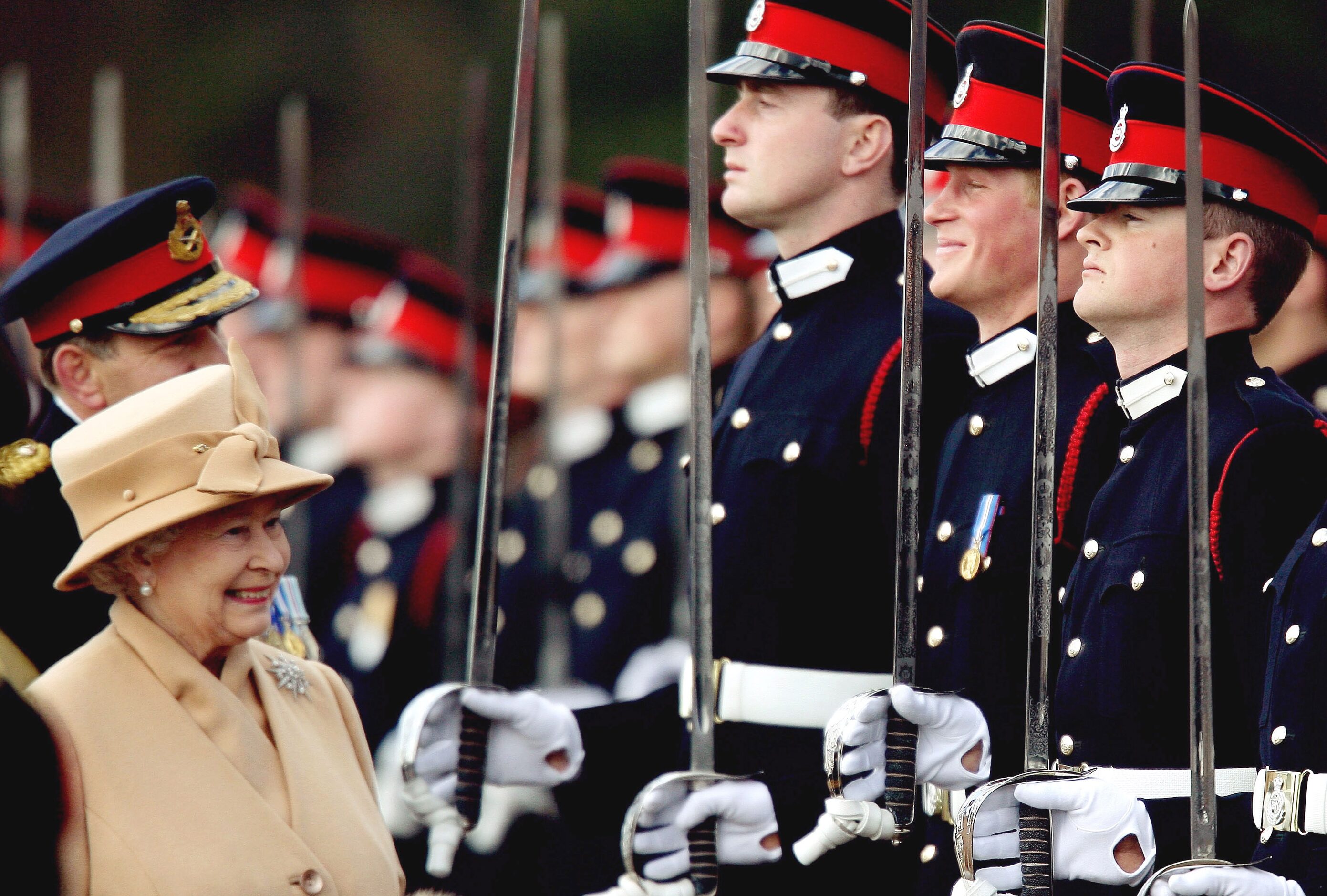 Britain's Prince Harry, second from right, grins and his grandmother Queen Elizabeth II...