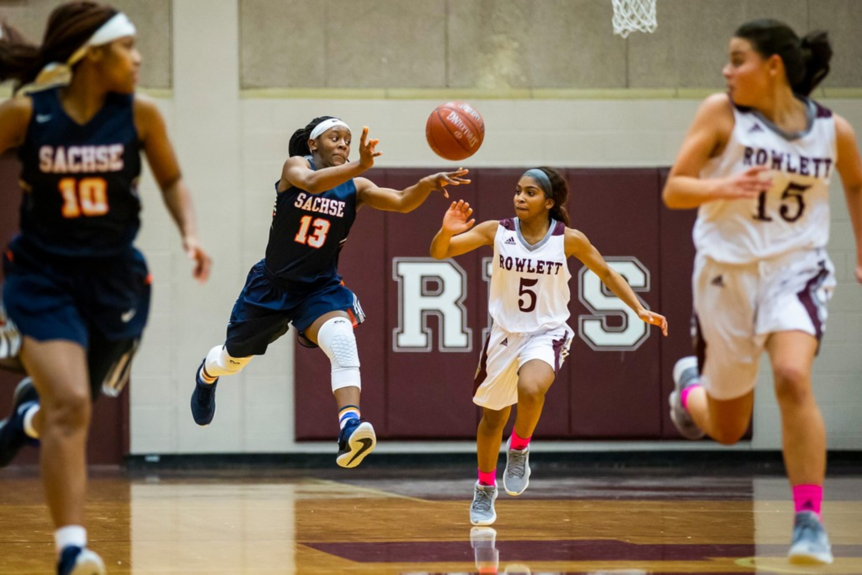 Sachse guard Jayla Brooks (13) pushes the ball up the floor as Rowlett guard Deja Duncan (5)...