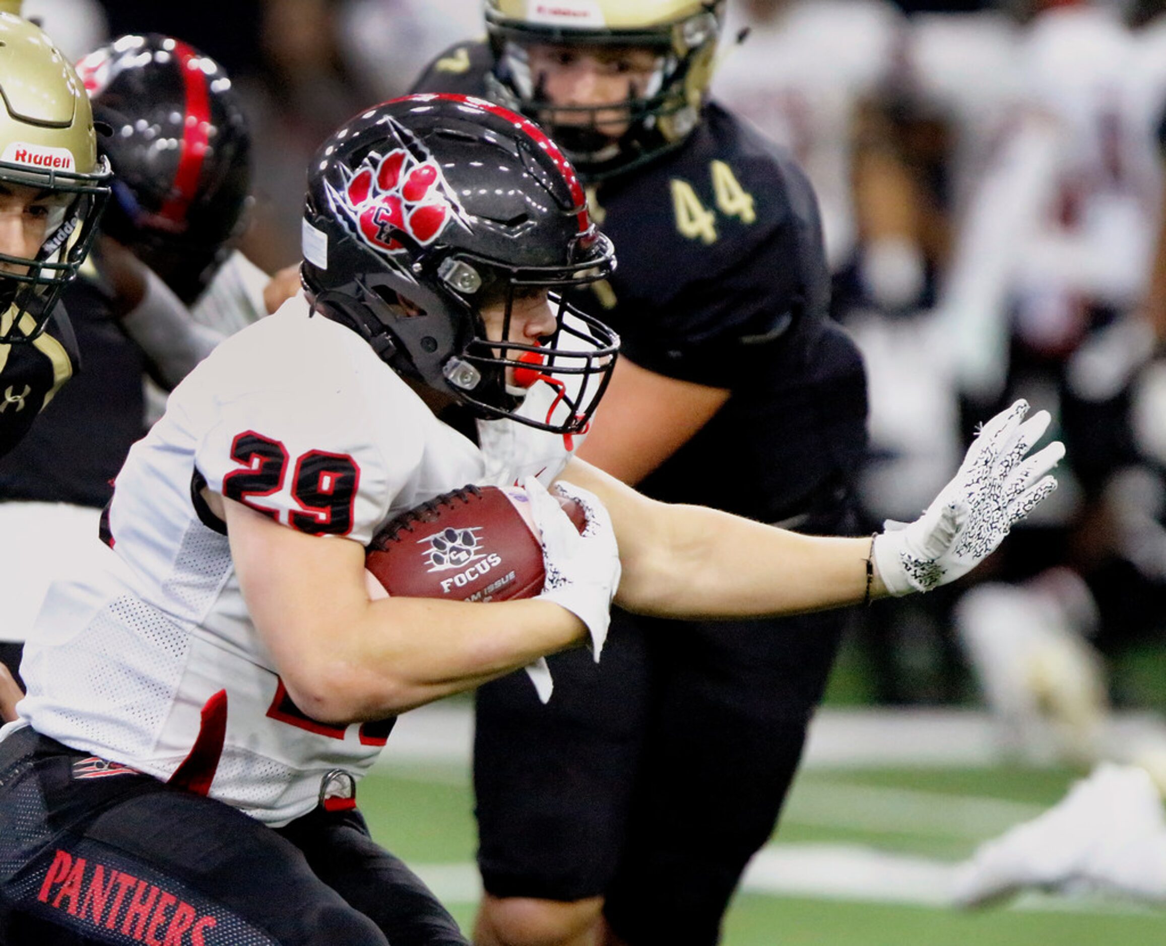 Colleyville Heritage High School running back Braxton Ash (29) prepares to stiff arm during...