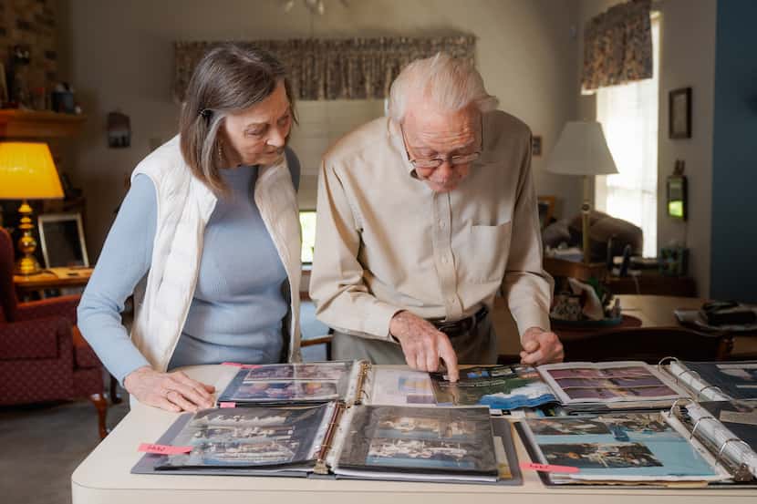 Carol Barlow, 76, and her father, LaVerne Biser, 105, looked at photographs of their...