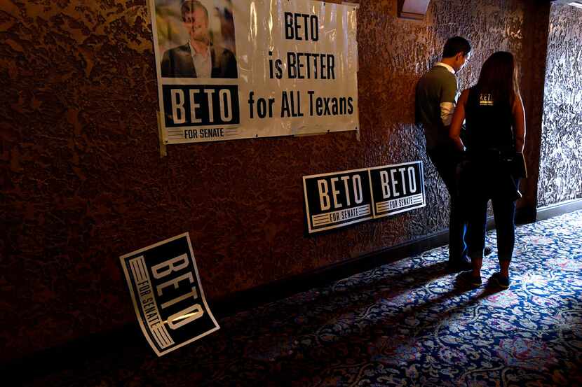 U.S. Senate candidate Beto O'Rourke read a message on his phone with a member of his...