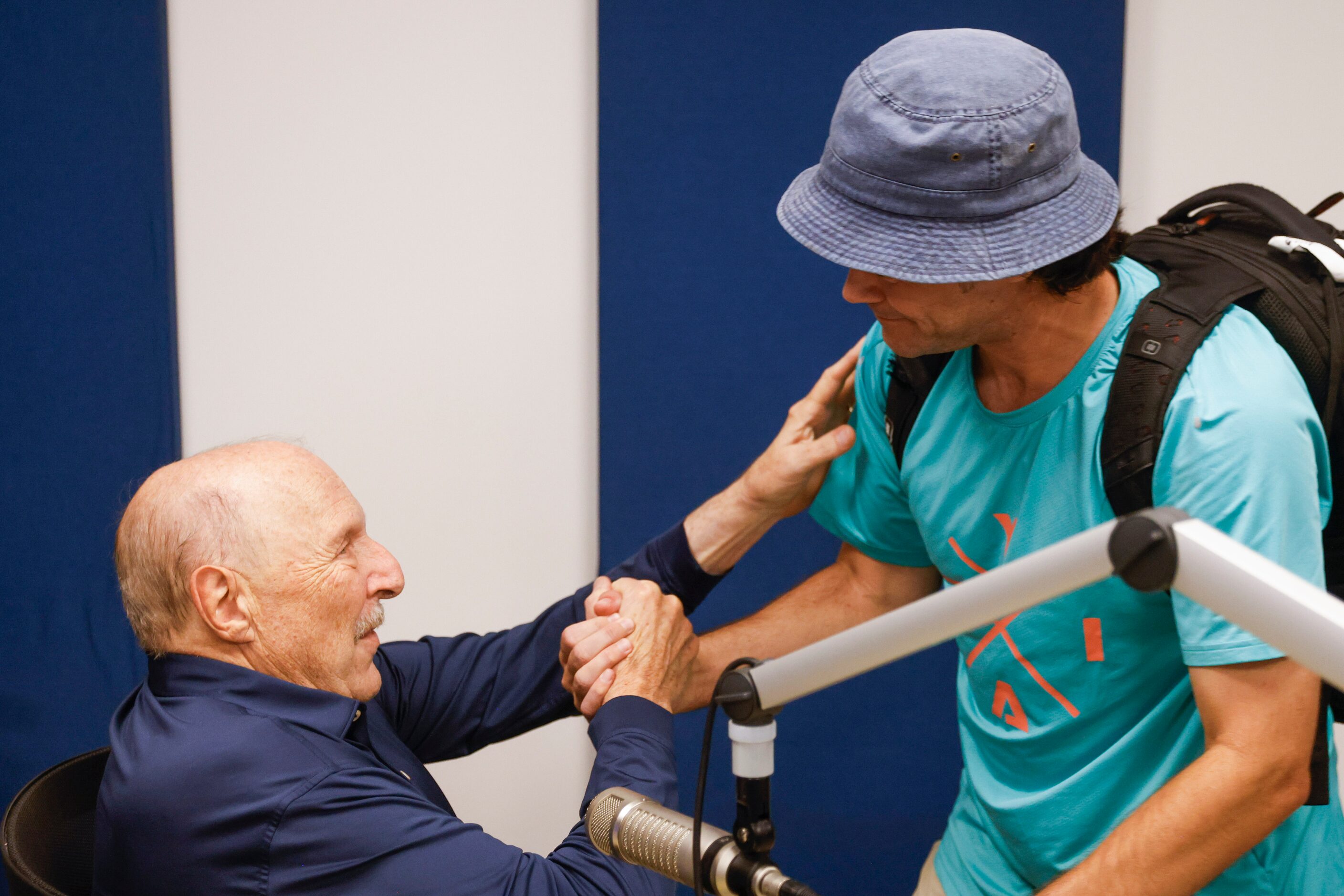 Local sports radio legend Norm Hitzges (left) shares a handshake with The Ticket radio...