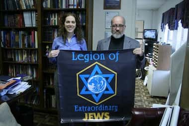 Deborah Fripp (left) and Geoffrey Dennis show off a banner for their fan organization within...