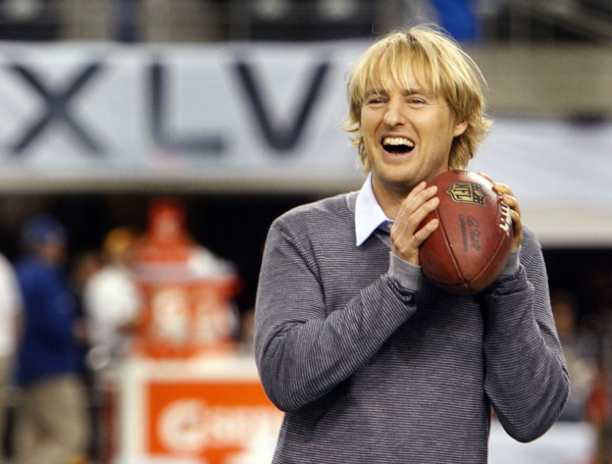 Dallas native Owen Wilson plays football on the field with friends on the NFL Network before...