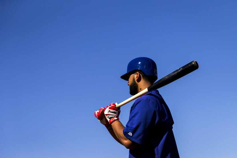 Texas Rangers outfielder Nomar Mazara waits to take his turn in the batting cage during a...